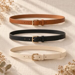 Tan, black and ivory belts arranged on linen
