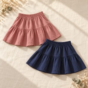 Rose and navy girls’ skirts on linen